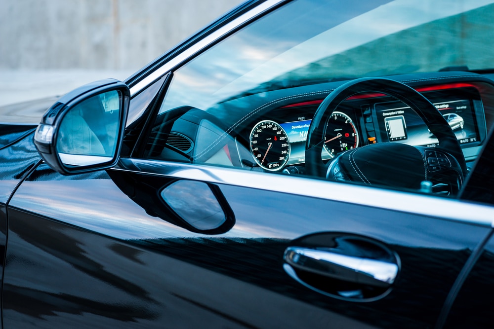 Luxury car interior details. Dashboard and steering wheel