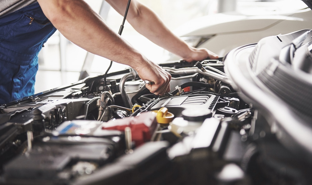 Auto mechanic working in garage.
