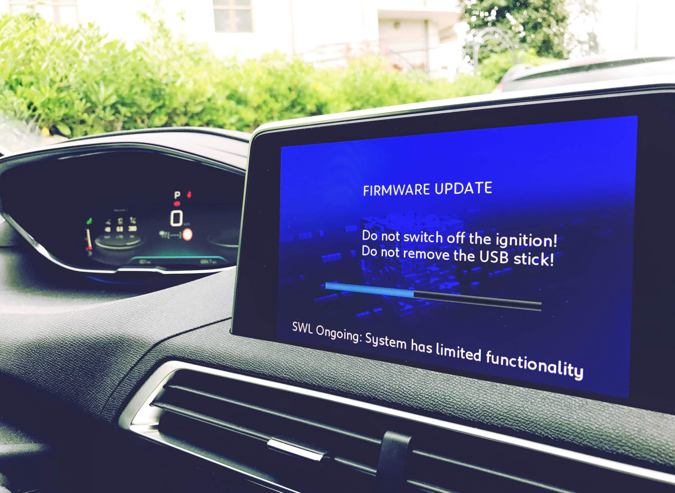 Vehicle display showing a firmware update in progress